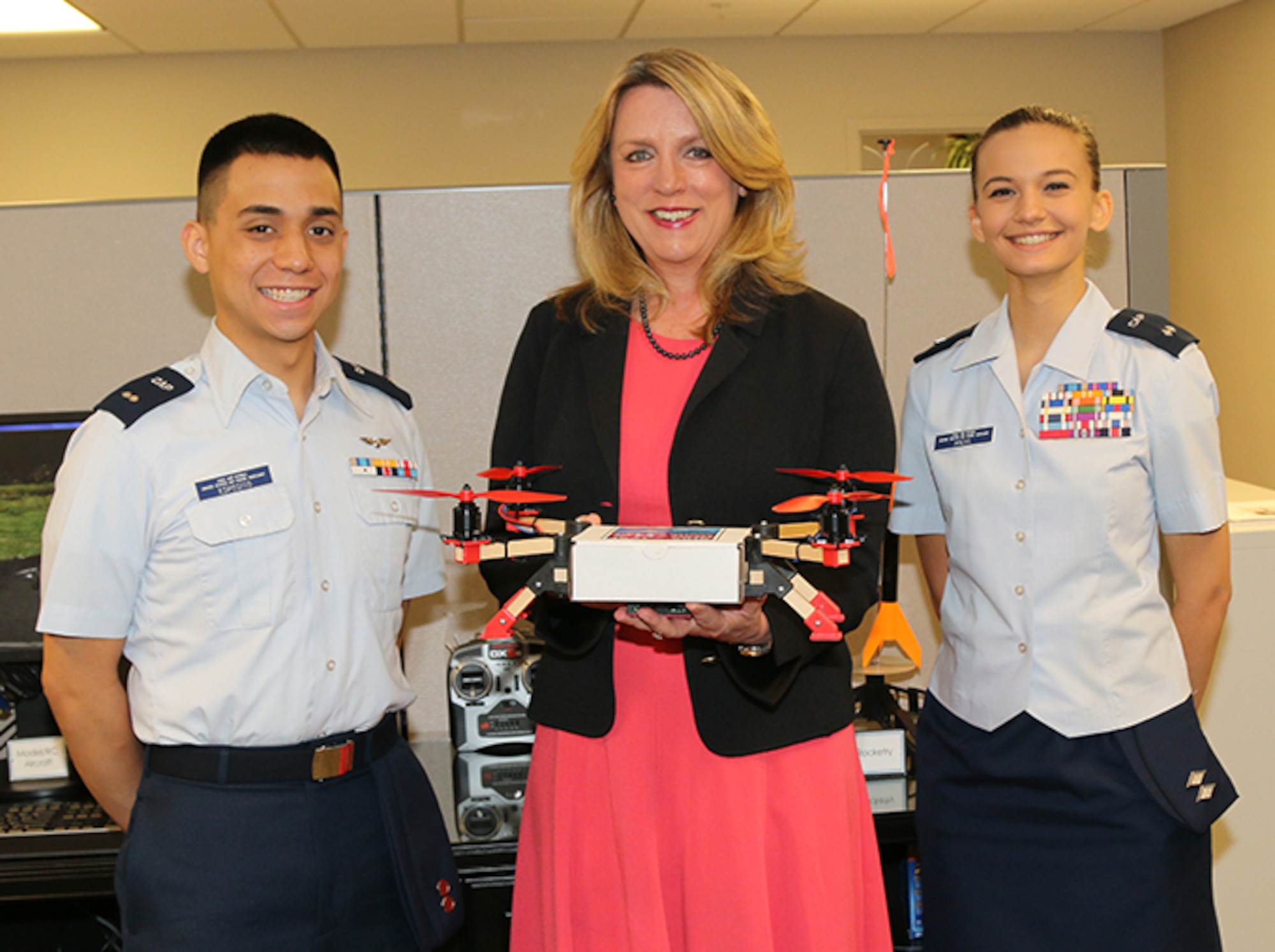Civil Air Patrol Cadet 1st Lt. Antonio Esposito (left) of the Tuscaloosa Composite Squadron and CAP Cadet Lt. Col. Ava Michl (right) of the Bessemer Composite Squadron show Secretary of the Air Force Deborah Lee James a “quadcopter” during her visit to National Headquarters Wednesday. The quadcopter is one of seven available CAP STEM (Science, Technology, Engineering and Math) Kits used to promote STEM careers nationwide.