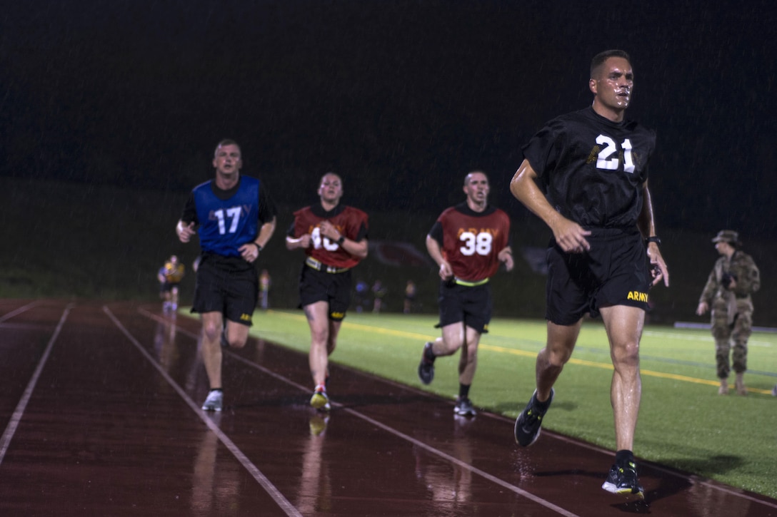 Army Reserve drill sergeant, Sgt. 1st Class Joshua Moeller, right, leads a group of runners through the rain during the 2016 U.S. Army Reserve Best Warrior Competition at Fort Bragg, N.C., May 3, 2016. Moeller is assigned to the 108th Training Command. Army photo Sgt. 1st Class Brian Hamilton