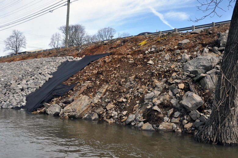 The U. S.  Army Corps of Engineers Nashville District and the city of Clarksville celebrated the completion of the Riverside Drive StreamBank Stabilization Project today during a ceremony at Freedom Point in Liberty Park. Crews cleared and prepared the site and used barges equipped with backhoe tractors to place a layers of geotextile fabric and riprap with limestone rock to stabilize the eroding bank.