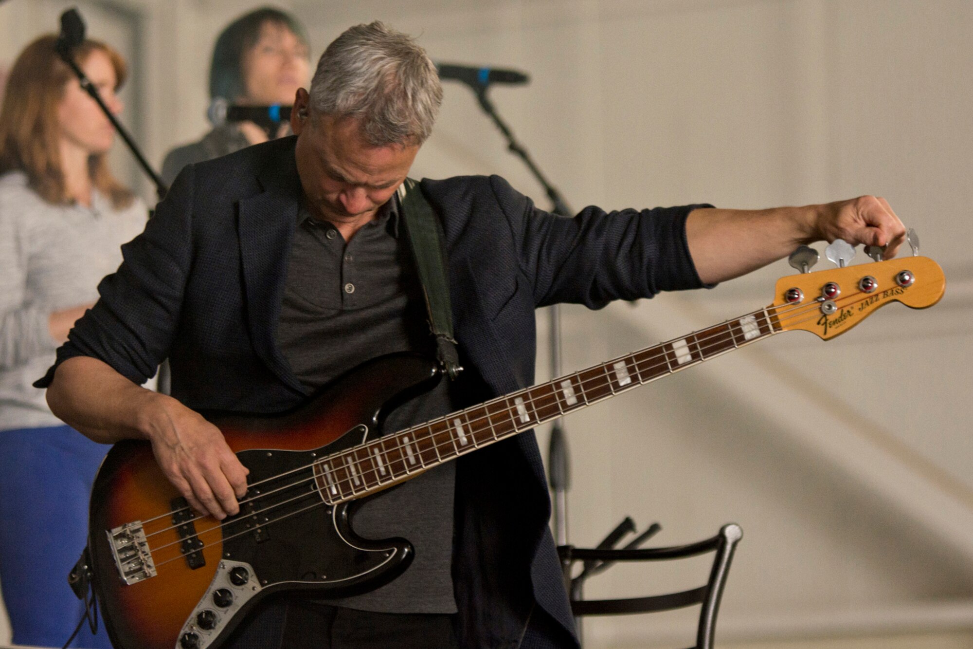 Gary Sinise tunes his guitar during a sound check session at Little Rock Air Force Base, Ark., April 29, 2016. Volunteers helped set the stage for Gary Sinise and The Lt. Dan Band to perform a free concert for the Airmen and their family members at Little Rock AFB. (U.S. Air Force photo by Master Sgt. Jeff Walston)    
