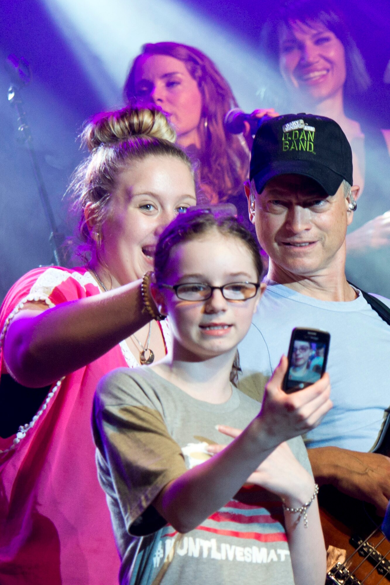 Actor and musician, Gary Sinise, engages with fans on stage as he performs with the Lt. Dan Band at Little Rock Air Force Base, Ark., April 29, 2016. The band, which is associated with the actor's charity foundation and the United Service Organizations, perform more than 40 concerts for military members and their families each year. (U.S. Air Force photo by Master Sgt. Jeff Walston)   