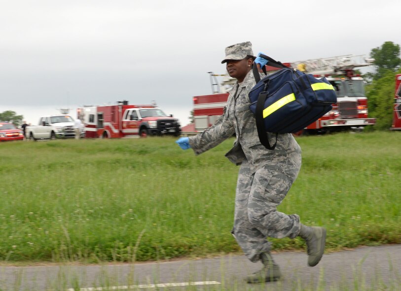 A first responder runs to provide aid to victims during a simulated accident at Barksdale Air Force Base, La., April 25, 2016. Practicing for emergency situations allows response agencies the opportunity to test readiness, evaluate emergency procedures, alleviate possible issues and, in the event something does occur, save lives. (U.S. Air Force photo/Airman 1st Class Curt Beach)
