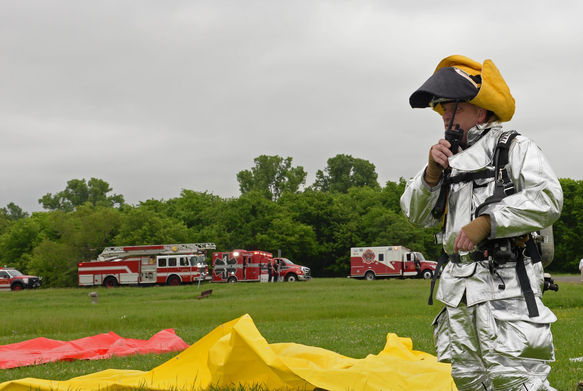 Adam Lynch, 2nd Civil Engineer Squadron fire chief, directs personnel via radio during a simulated emergency at Barksdale Air Force Base, La., April 25, 2016. The installation’s emergency responders worked alongside partnering agencies from around the community, a critical relationship throughout a disaster, to ensure unified operations. (U.S. Air Force photo/Airman 1st Class Curt Beach)