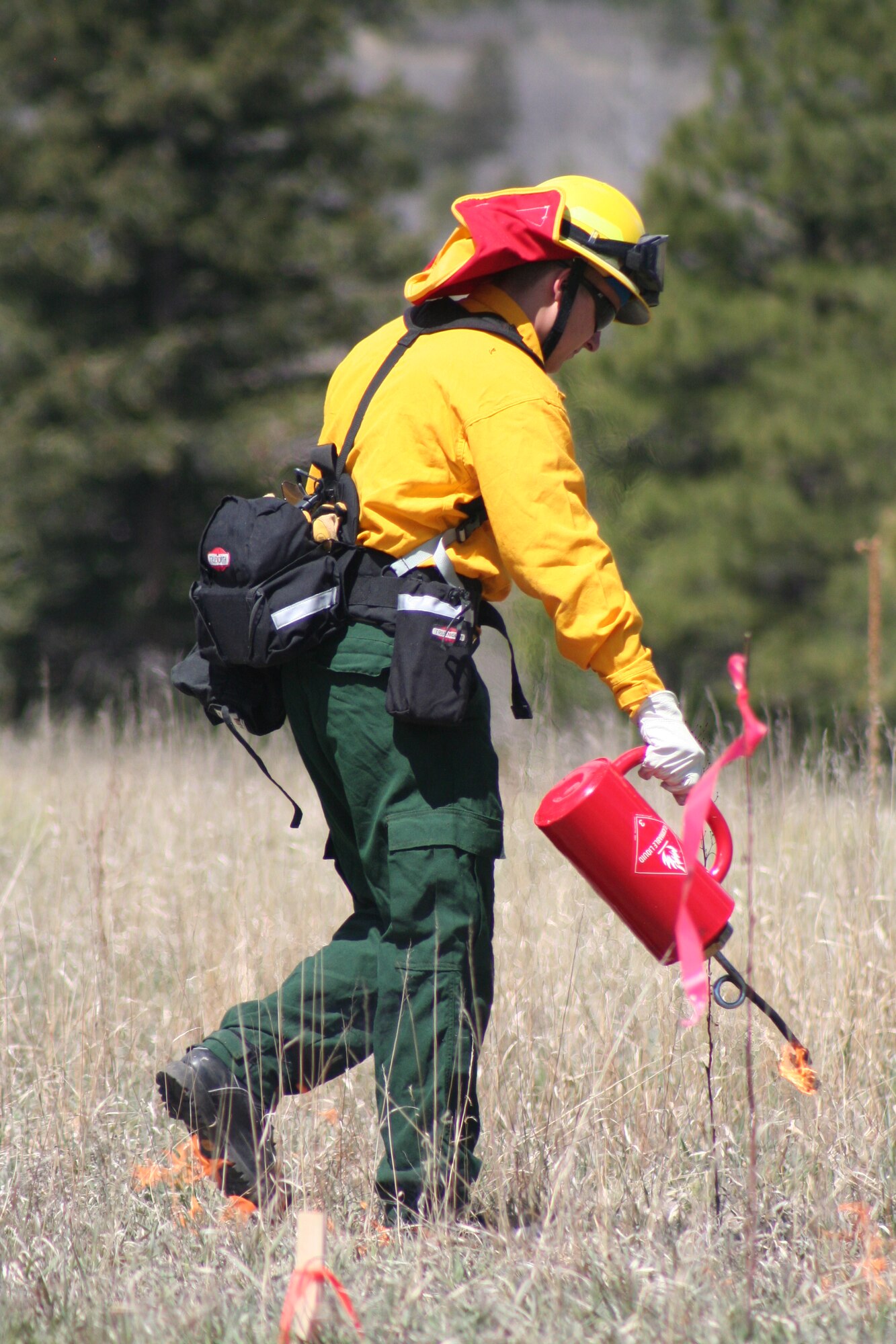A firefighter at the U.S. Air Force Academy monitors a controlled-burn. (U.S. Air Force photo)