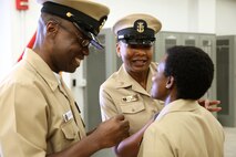 Master Chief Petty Officer April D. Beldo, fleet master chief of Manpower, Personnel, Training and Education (center), and Master Chief Petty Officer Henry Kuedituka (left) pin on the rank of Master Chief Petty Officer to Richmond, Va.-native Mercedes N. Hargrove during a promotion ceremony at Naval Support Facility Indian Head, Md., May 4, 2016. Hargrove serves as the Navy Senior Enlisted Leader with Chemical Biological Incident Response Force. (Official USMC Photo by Sgt. Jonathan Herrera/Released)