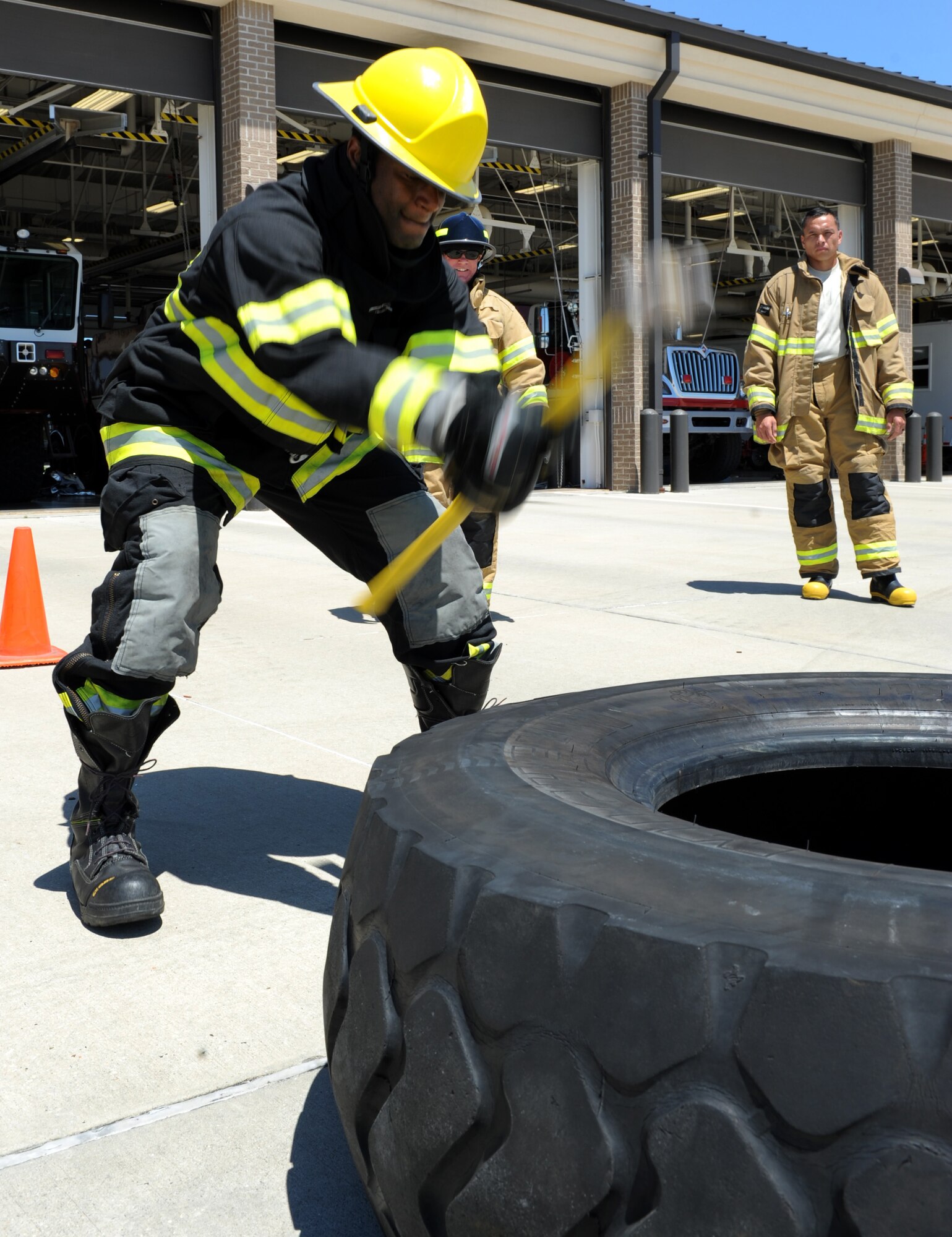 Tech. Sgt. Lawrence Ricks, 81st Infrastructure Division firefighter, hits a tire with a hammer at the Keesler Fire Department as he trains for the 2016 Firefighter Combat Challenge Competition Wild Card Week, May 4, 2016, Keesler Air Force Base, Miss. Four members from the fire department competed in the qualifying round at Lake Charles, La., Apr. 30. (U.S. Air Force photo by Kemberly Groue)