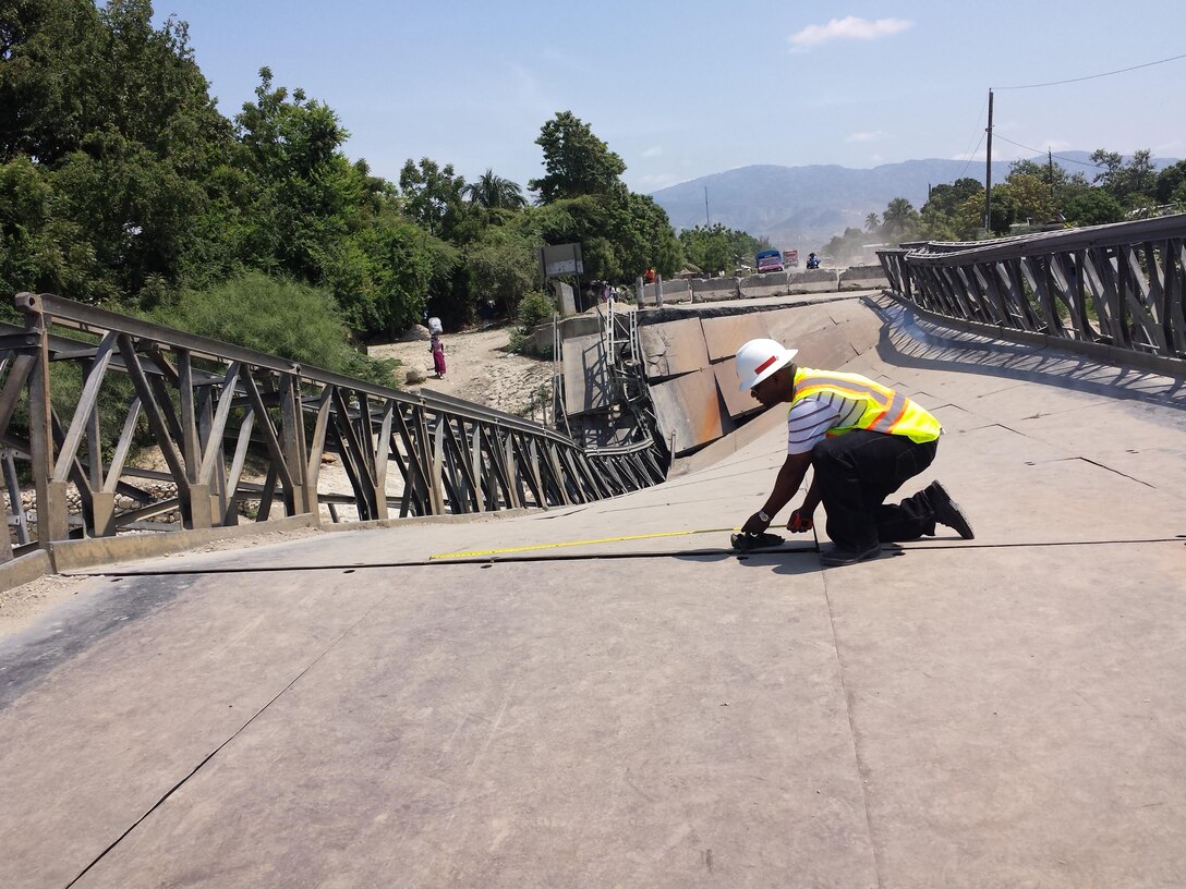 Project Manager Tim Brown measures and surveys portions of the collapsed Duviver Bridge during the Corps’ visit to Haiti in April.