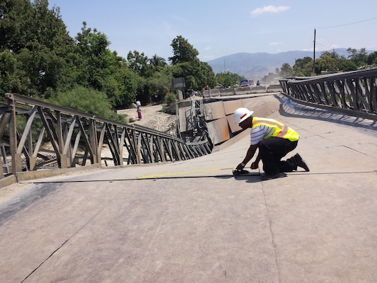 Project Manager Tim Brown measures and surveys portions of the collapsed Duviver Bridge during the Corps’ visit to Haiti in April.