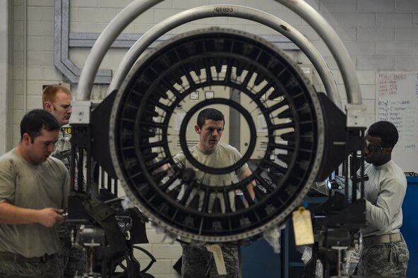 Airmen with the 52nd Aircraft Maintenance Squadron work on an engine at U.S. Air Forces in Europe's only F110 engine overhaul facility at Spangdahlem Air Base, Germany, April 19, 2016, during a weeklong civic leader trip to several bases in Europe. Air Force civic leaders are unpaid advisers, key communicators and advocates for the Air Force. (U.S. Air Force photo/Tech. Sgt. Joshua DeMotts)