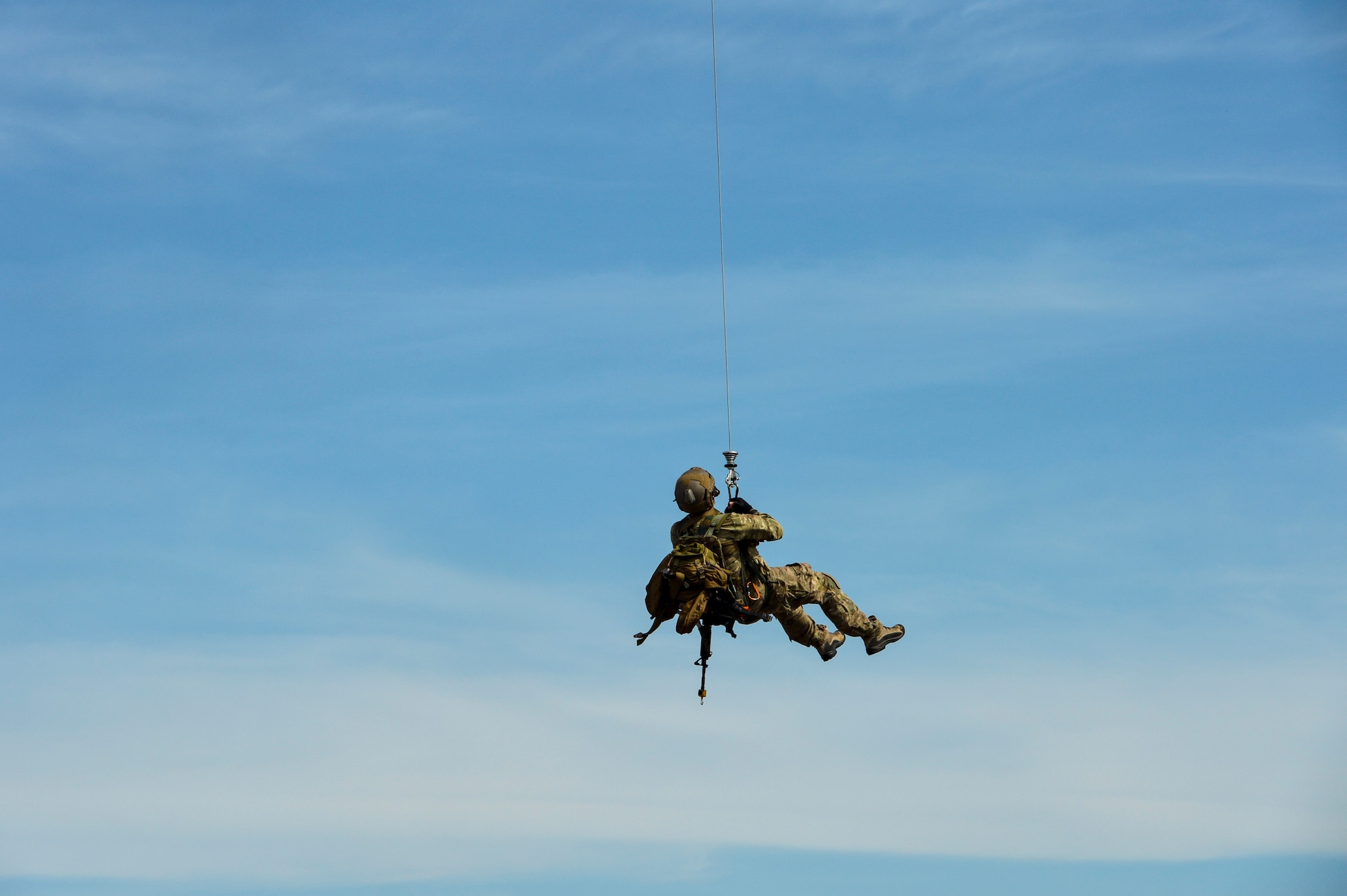 A pararescueman with the 57th Rescue Squadron is hoisted onto an HH-60 Pave Hawk from the 56th Rescue Squadron at Royal Air Force Lakenheath, England, during a combat search and rescue demonstration April 21, 2016, for a group of Air Force civic leaders, who serve as unpaid advisers, key communicators and advocates for the Air Force. (U.S. Air Force photo/Tech. Sgt. Joshua DeMotts)