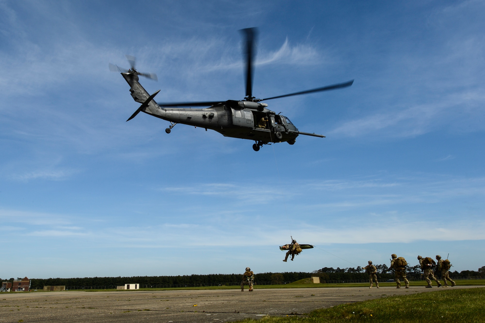 A group of pararescuemen with the 57th Rescue Squadron hoist a simulated injured Airman onto an HH-60 Pave Hawk from the 56th Rescue Squadron at Royal Air Force Lakenheath, England, as they conduct a combat search and rescue demonstration April 21, 2016, for a group of Air Force civic leaders, who serve as unpaid advisers, key communicators and advocates for the Air Force. (U.S. Air Force photo/Tech. Sgt. Joshua DeMotts)