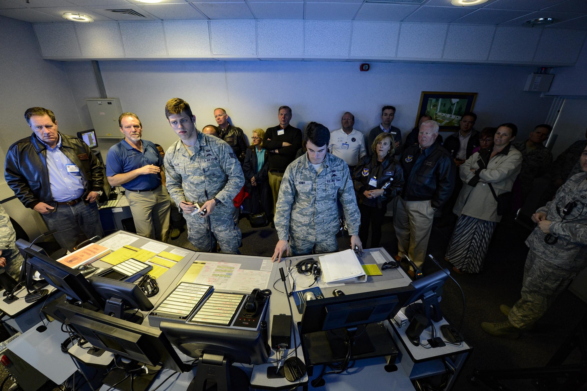 A group of Air Force civic leaders watch a virtual control tower trainer demonstration at Royal Air Force Mildenhall England, April 19, 2016, during a weeklong civic leader trip to several bases in Europe. Air Force civic leaders are unpaid advisers, key communicators and advocates for the Air Force, April 19, 2016. (U.S. Air Force photo/Tech. Sgt. Joshua DeMotts)