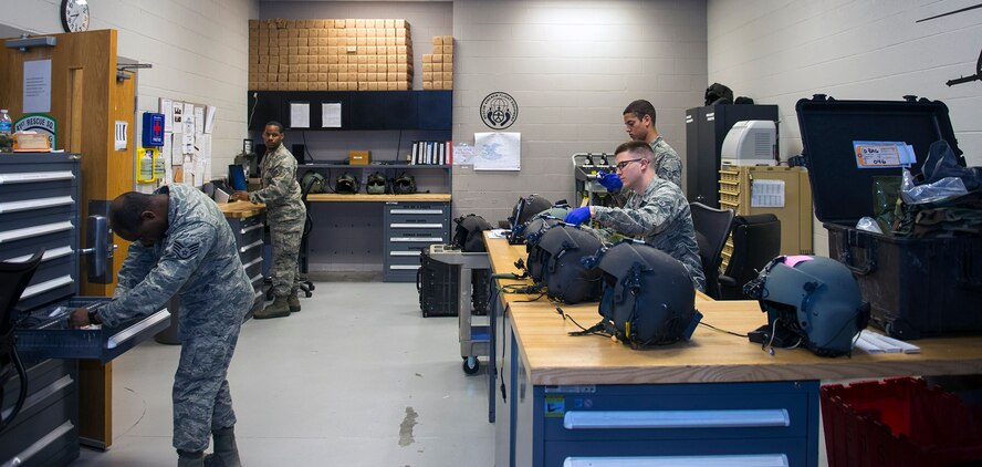 U.S. Air Force Airmen from the 347th Operations Support Squadron’s aircrew flight equipment shop inspect HGU-56P flight helmets for HH-60G Pave Hawk aircrew members, May 5, 2016, at Moody Air Force Base, Ga. AFE specialists are responsible for packing aircrew survival kits and ensuring their equipment is safe, in addition to maintaining helmets and oxygen masks. (U.S. Air Force photo by Airman 1st Class Greg Nash/Released) 