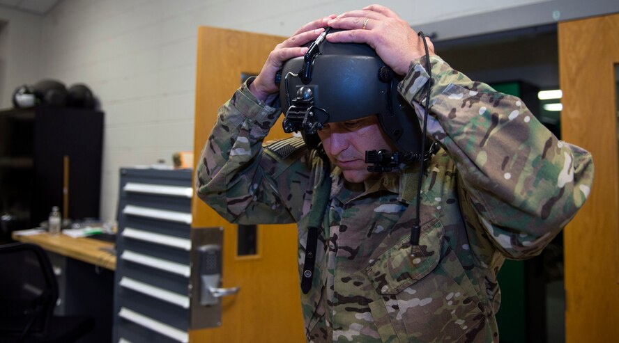 U.S. Air Force Chief Master Sgt. David Kelch, 23d Wing command chief, ensures his HGU-56P flight helmet fits properly before his fini-flight, May 5, 2016, at Moody Air Force Base, Ga. AFE specialists tell aircrew members the purpose and how to operate their flight and chemical defense equipment, in addition to fitting aircrew members for their equipment. (U.S. Air Force photo by Airman 1st Class Greg Nash/Released) 