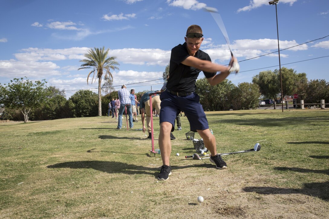 James Middleton, 7, attempts to hit a target with a ball to dunk his father, Lt. Col. Brian Middleton, battalion commander, 3rd Battalion, 4th Marines, 7th Marine Regiment, during the battalion’s Family Day at Desert Winds Golf Course April 29, 2016. (Official Marine Corps photo by Lance Cpl. Levi Schultz/Released)