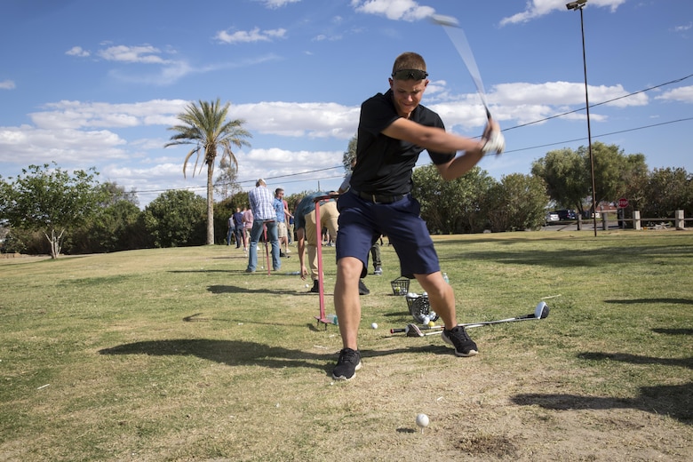 James Middleton, 7, attempts to hit a target with a ball to dunk his father, Lt. Col. Brian Middleton, battalion commander, 3rd Battalion, 4th Marines, 7th Marine Regiment, during the battalion’s Family Day at Desert Winds Golf Course April 29, 2016. (Official Marine Corps photo by Lance Cpl. Levi Schultz/Released)