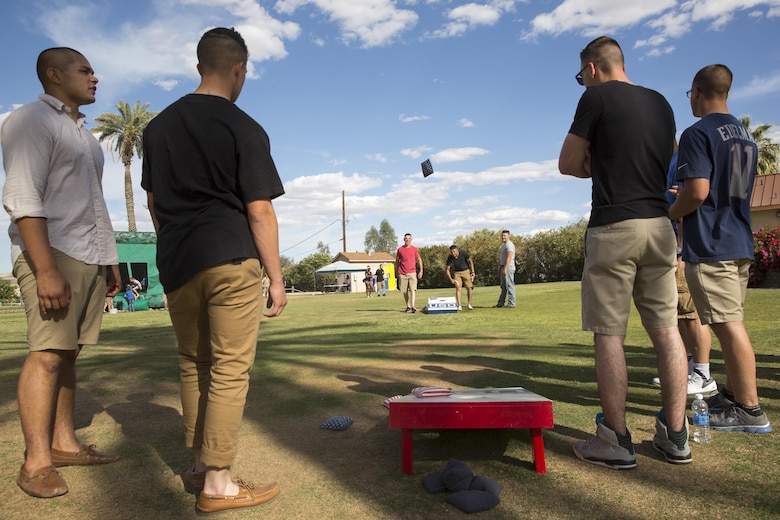 James Middleton, 7, attempts to hit a target with a ball to dunk his father, Lt. Col. Brian Middleton, battalion commander, 3rd Battalion, 4th Marines, 7th Marine Regiment, during the battalion’s Family Day at Desert Winds Golf Course April 29, 2016. (Official Marine Corps photo by Lance Cpl. Levi Schultz/Released)