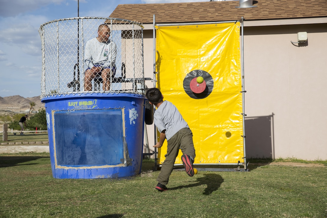 James Middleton, 7, attempts to hit a target with a ball to dunk his father, Lt. Col. Brian Middleton, battalion commander, 3rd Battalion, 4th Marines, 7th Marine Regiment, during the battalion’s Family Day at Desert Winds Golf Course April 29, 2016. (Official Marine Corps photo by Lance Cpl. Levi Schultz/Released)