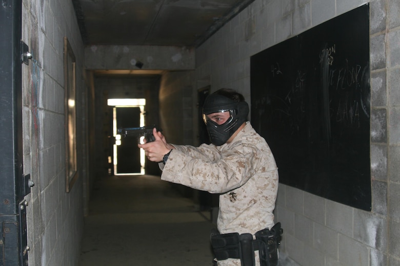 Cpl. Devin Kirkman waits for his partner to join him so that they can clear a room together during active shooter training at the MOUT facility on Marine Corps Base Quantico April 19.