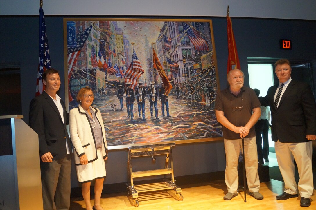 Artist Philip Corley (second from right) stands with his family in front of his painting “Coming Home,” which he donated to the National Museum of the Marine Corps at a ceremony Apr. 20. His sons Tom and Stephen and their mother Geraldine Corley-Donnelly are with him.