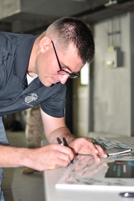 Staff Sgt. Kenneth Kelch, unit victim advocate for Marine Corps Air Facility, signed a Sexual Assault Awareness poster on April 22 during the first Denim Day event.