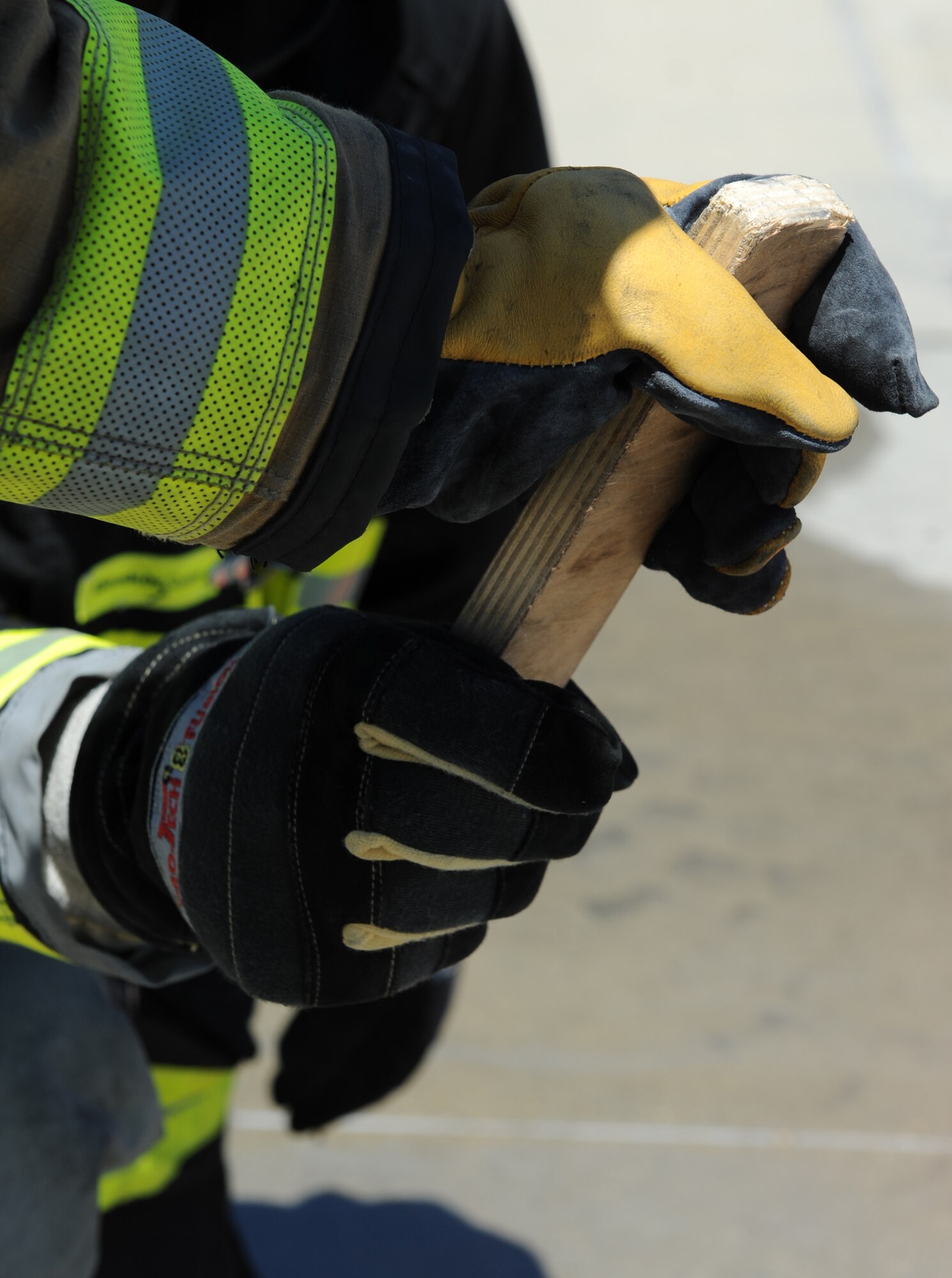 A make-shift baton is passed between two firemen as they train at the Keesler Fire Department for the 2016 Firefighter Combat Challenge Competition Wild Card Week, May 4, 2016, Keesler Air Force Base, Miss. Four members from the fire department competed in the qualifying round at Lake Charles, La., Apr. 30. (U.S. Air Force photo by Kemberly Groue)