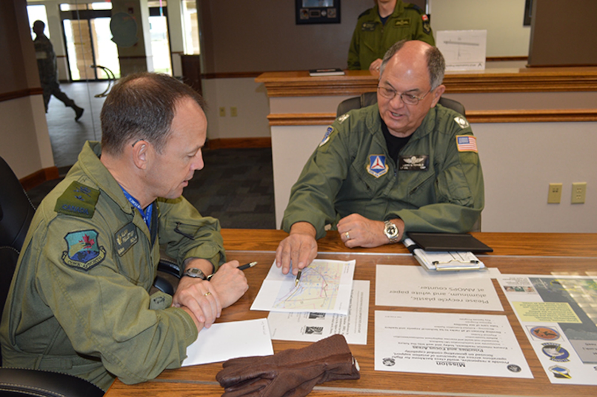 01.	BGen Alain Pelletier, Continental U.S. Aerospace Defense Region Deputy Commander, listens as Florida Wing Civil Air Patrol Lt. Col. Larry Fernald briefs a point about the CAP mission they are going to fly from Tyndall Air Force Base. Pelletier flew an orientation flight May 2 with Fernald to familiarize himself about the CAP missions in the region that include fire watch in the Eglin Air Force Base, Fla., area and search and rescue upon request. (USAF Photo released by Mary McHale)