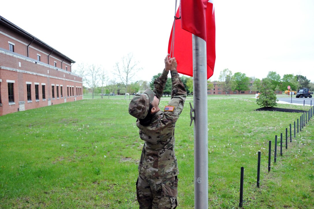 Spc. Dibriana Rivas, a Yellow Ribbon event coordinator with the U.S. Army Reserve’s 99th Regional Support Command at Joint Base McGuire-Dix-Lakehurst, New Jersey, raises the 4-star flag May 4 in advance of a visit by Gen. Robert B. Abrams, the U.S. Forces Command commanding general.