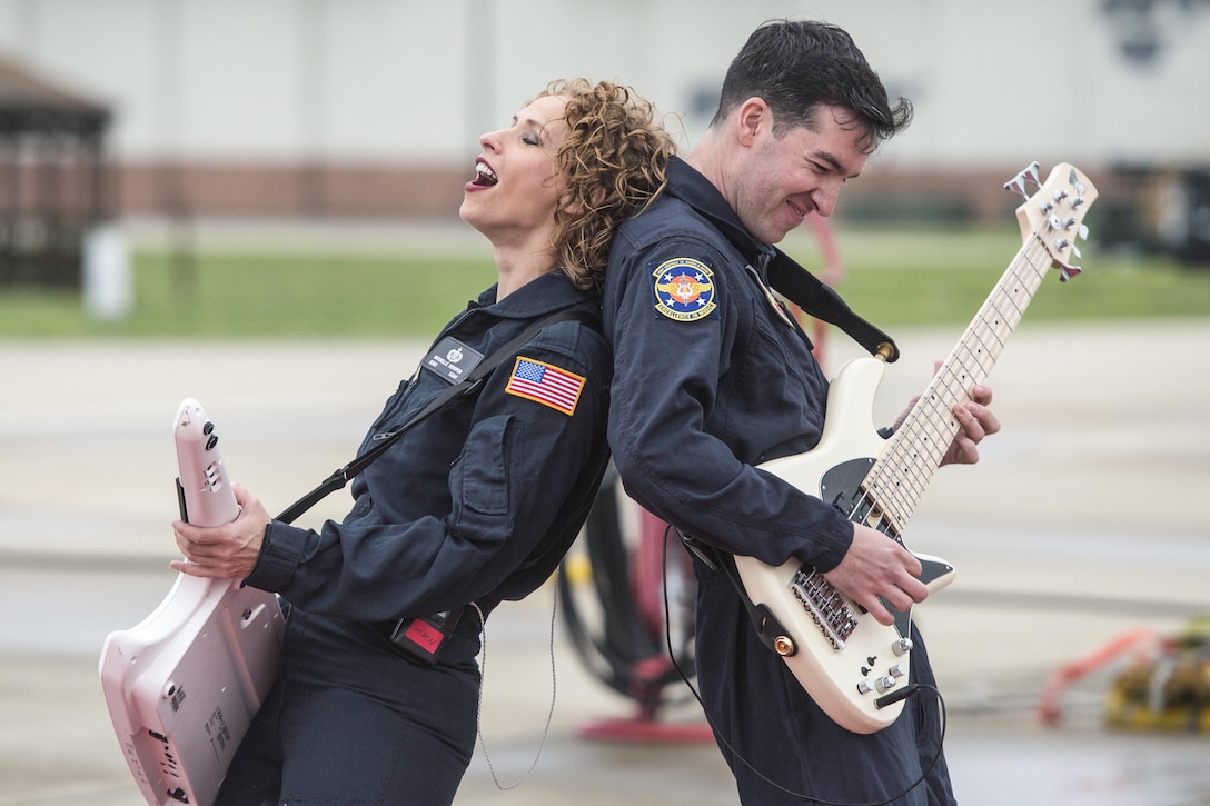 Air Force Tech. Sgt. Michelle Hooper, left, and Staff Sgt. Jordan Kimble perform with Full Spectrum, a six-piece band, in front of airmen at Langley Air Force Base, Va., May 4, 2016. The band is from the U.S. Air Force Heritage of America Band. Air Force photo by Senior Airman Kayla Newman