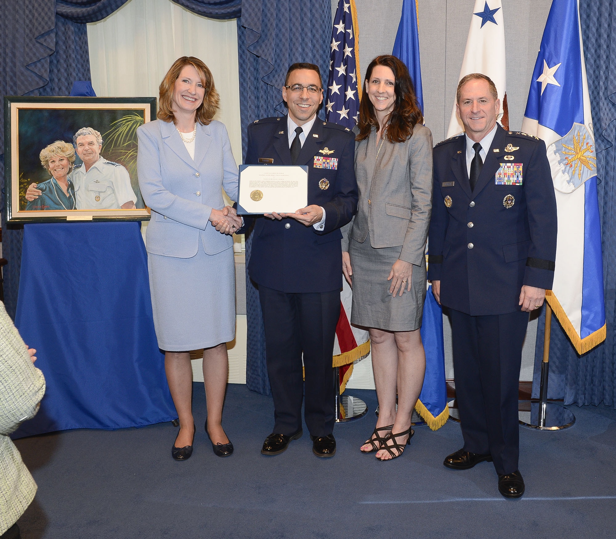 Under Secretary of the Air Force Lisa Disbrow and Air Force Vice Chief of Staff Gen. David L. Goldfein present the 2015 General and Mrs. Jerome F. O' Malley Award to Col. William Liquori Jr. and his wife, Amy, during a ceremony in the Pentagon, May 3, 2016.  The award was earned during the Liquoris’ time leading the 50th Space Wing at Schriever Air Force Base, Colo. (U.S. Air Force photo/Andy Morataya)