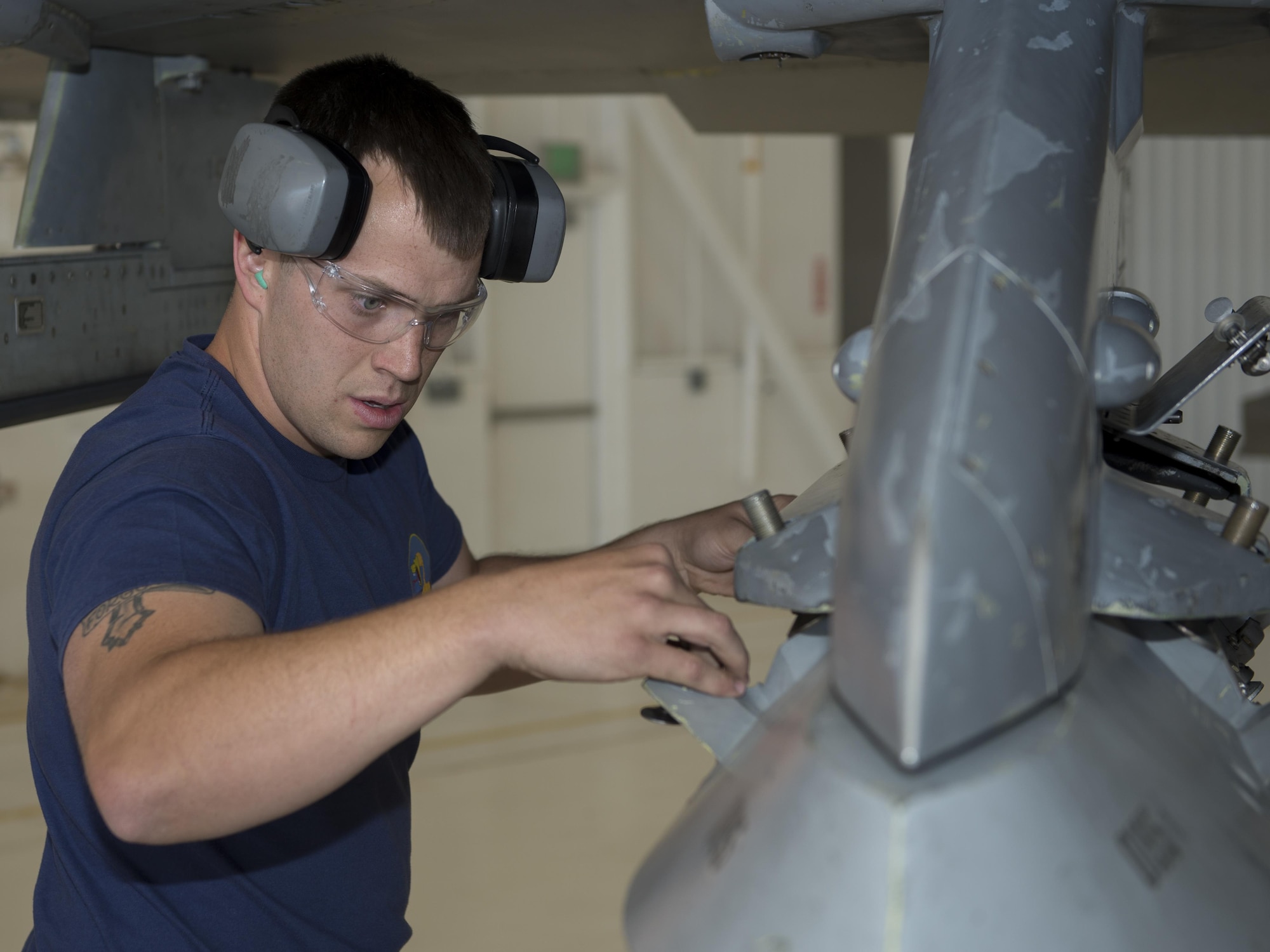 Senior Airman Caleb, a 54th Fighter Group weapons load crew member from Holloman Air Force Base, N.M., inspects the connection points of a training bomb during the annual load competition here May 4. Teams from the 54th Fighter Group and the 49th Aircraft Maintenance Squadron here competed by testing their ability to quickly load training weapon systems onto their respective aircraft. (Last names are withheld due to operational requirements) (U.S. Air Force photo by Airman 1st Class Randahl J. Jenson)    