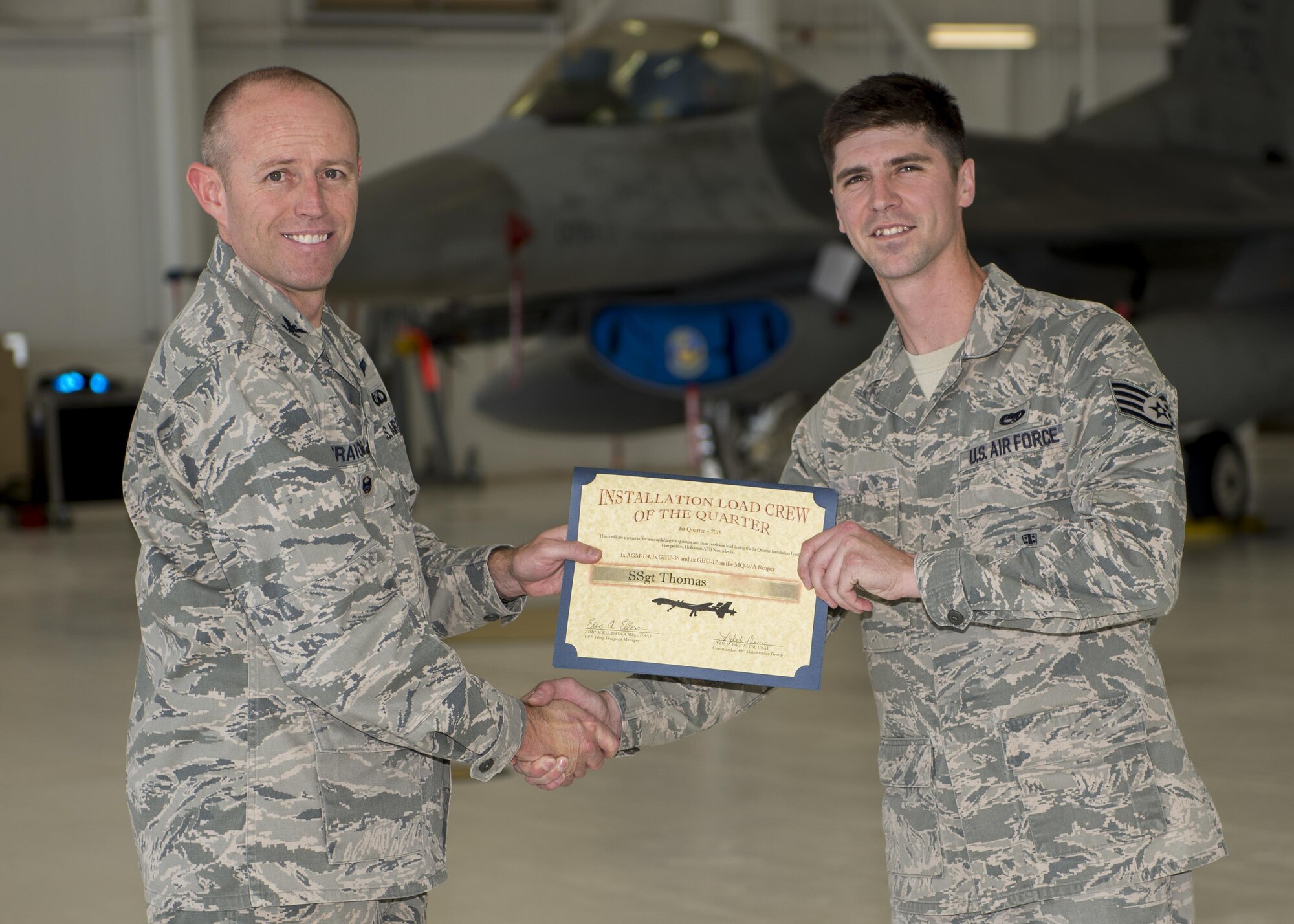 Col. Ryan Craycraft, the 49th Wing vice commander, presents an award to Staff Sgt. Thomas, a 49th Aircraft Maintenance Squadron load crew member from Holloman Air Force Base, N.M., after Thomas’s team won the annual load completion here May 4. Teams from the 54th Fighter Group and the 49th Aircraft Maintenance Squadron here competed by testing their ability to quickly load training weapon systems onto their respective aircraft. (Last names are withheld due to operational requirements) (U.S. Air Force photo by Airman 1st Class Randahl J. Jenson)