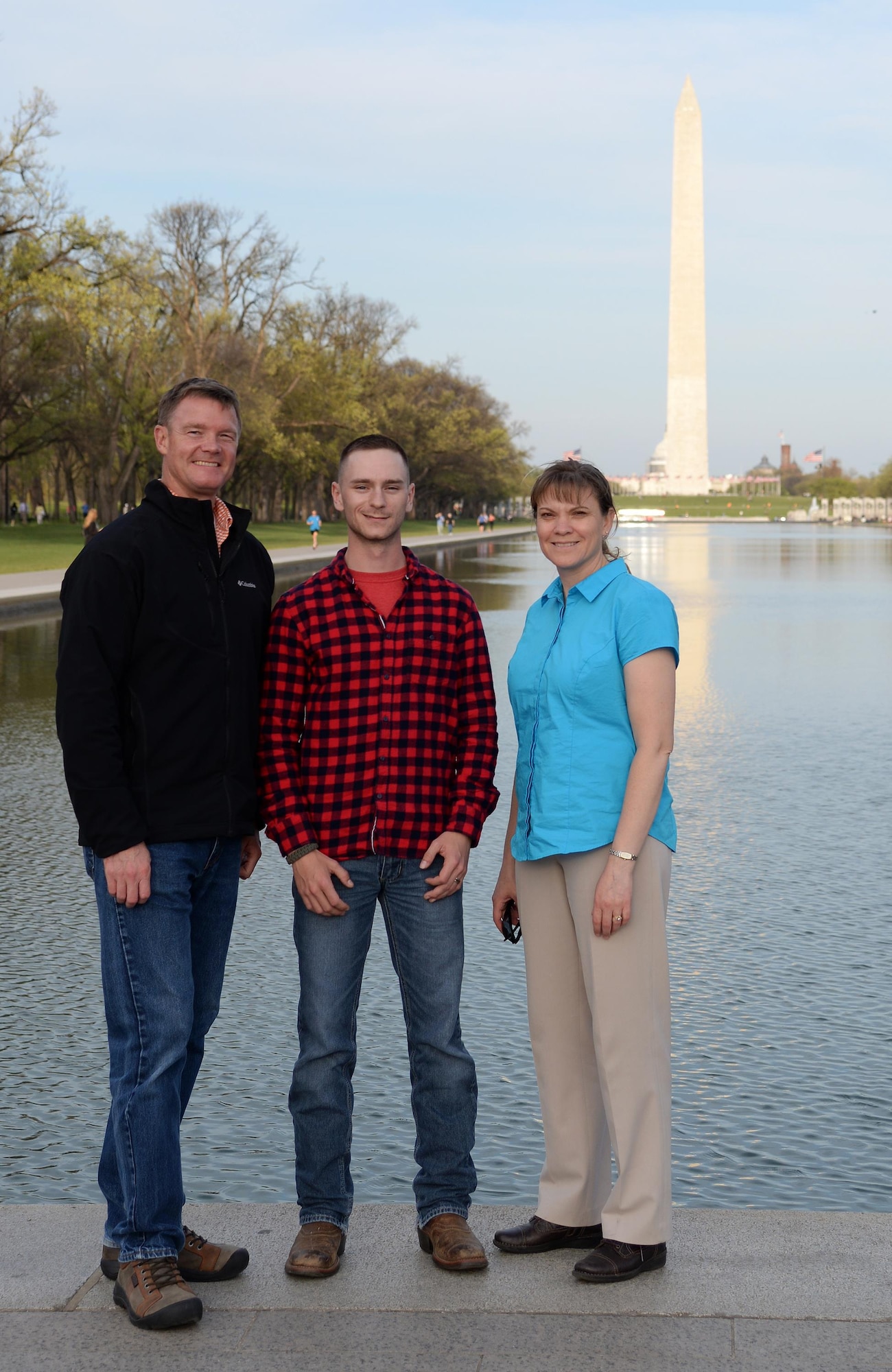 Staff Sgt. Cody Sparks, center, Air Education and Training Command Airman of the Year, poses with Col. Thomas Shank, left, 47th Flying Training Wing commander, and Chief Master Sgt. Teresa Clapper, right, 47th FTW command chief, in front of the Washington Monument April 11, 2016. The trio visited Capitol Hill to inform congressional leadership about Laughlin Air Force Base.