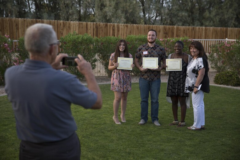 Students take photos with friends and families after receiving scholarships during the annual Officers’ Spouses’ Club Scholarship and Grant Awards Reception at Quarters One May 3, 2016. (Official Marine Corps Photo by Cpl. Julio McGraw/Released)