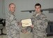 Col. Ryan Craycraft, the 49th Wing vice commander, presents an award to Senior Airman Christopher, a 49th Aircraft Maintenance Squadron load crew member from Holloman Air Force Base, N.M., after Christopher’s team won the annual load completion here May 4. Teams from the 54th Fighter Group and the 49th Aircraft Maintenance Squadron here competed by testing their ability to quickly load training weapon systems onto their respective aircraft. (Last names are withheld due to operational requirements) (U.S. Air Force photo by Airman 1st Class Randahl J. Jenson)  