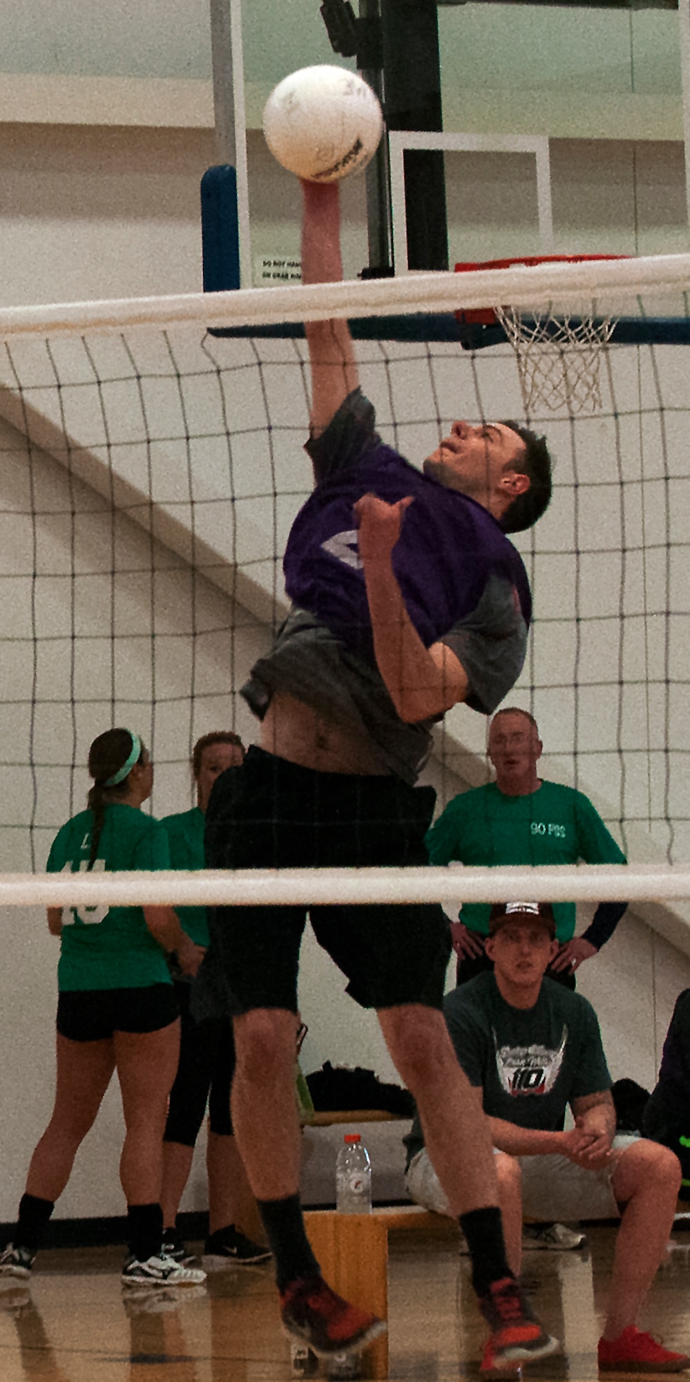 Bryan Patterson, 90th Security Forces Squadron intramural volleyball team member, hits a volley ball over the net during an intramural volleyball semi-finals match May 4, 2016, inside the Freedom Hall Fitness Center on F.E. Warren Air Force Base, Wyo. Patterson placed extreme faith in his team since game one, saying they would make it to, and win the championship. (U.S. Air Force photo by Senior Airman Brandon Valle)