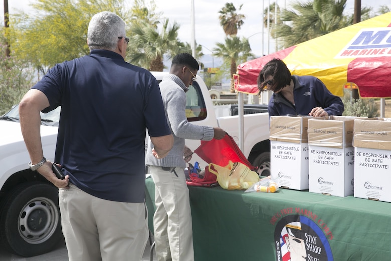 Members of the Criminal Investigation Division help a Combat Center patron dispose of their prescription medication during the Provost Marshal’s Office Prescription Drug Take Back held at the base exchange parking lot April 30, 2016. (Official Marine Corps photo by Cpl. Thomas Mudd/Released)