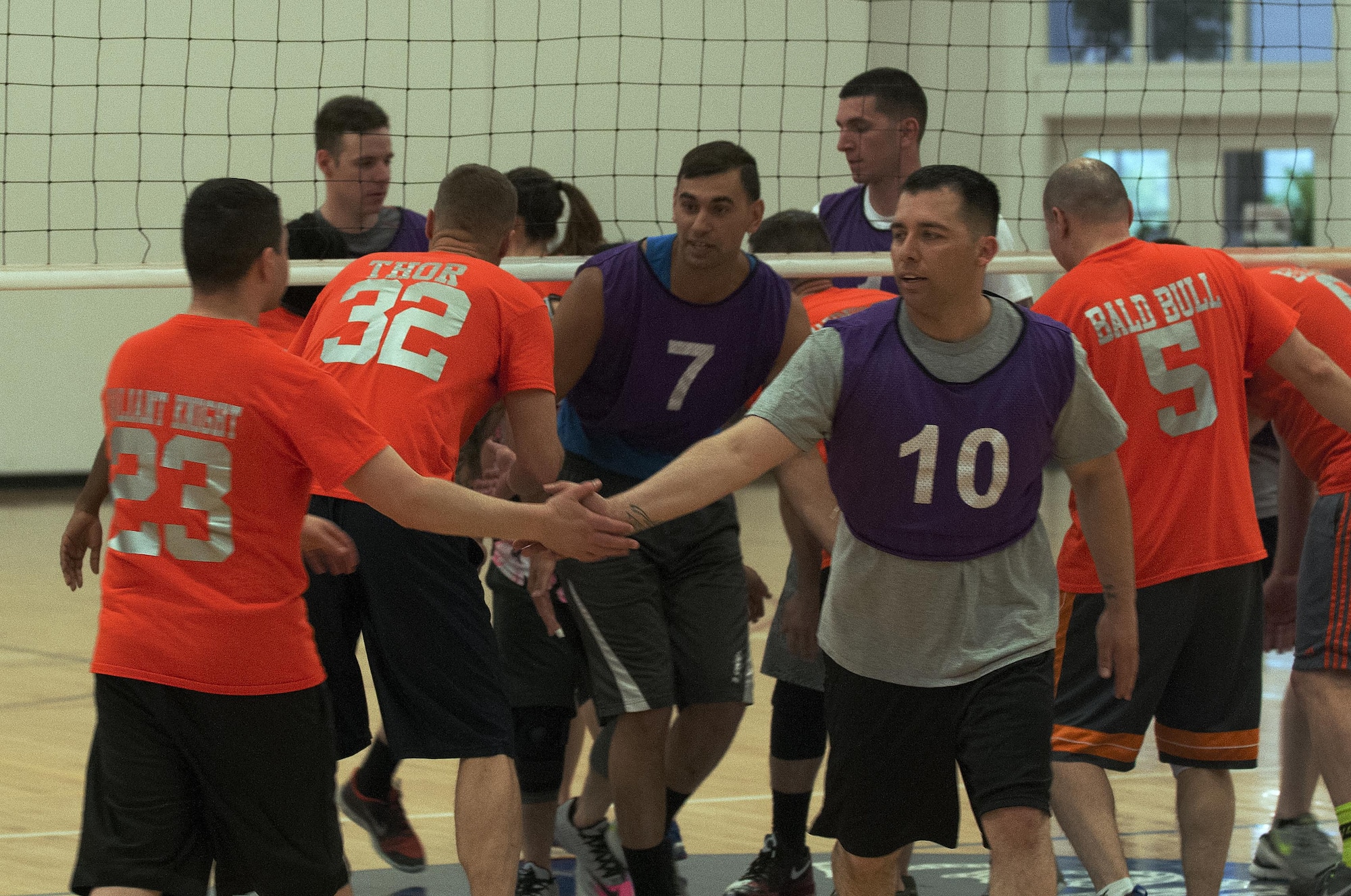 The 90th Security Forces Squadron and the 90th Medical Group intramural volleyball teams shake hands as they switch sides between matches of the championship game May 4, 2016, inside the Freedom Hall Fitness Center on F.E. Warren Air Force Base, Wyo. Both teams fought for the championship over three matches, with the 90th SFS team pulling the final win. (U.S. Air Force photo by Senior Airman Brandon Valle)