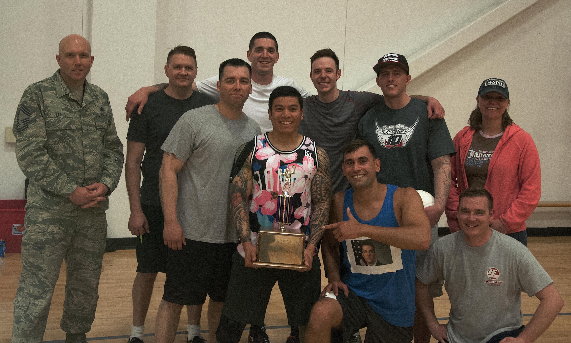 The 90th Security Forces Squadron intramural volleyball team poses with Chief Master Sgt. Brian Lewis, 90th SFS security forces manager, and Senior Master Sgt. Rebecca McNelley, 90th SFS, after winning the championship game May 4, 2016, inside the Freedom Hall Fitness Center on F.E. Warren Air Force Base, Wyo. The team beat the 90th Medical Group 15 to 11 points in the final match to claim the victory. (U.S. Air Force photo by Senior Airman Brandon Valle) 