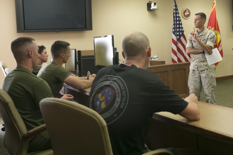 Maj. Michael McDonald, senior trial councilman, Legal Services Support Team, gives an explains components of a sexual assault trial to the 3rd Light Armored Reconnaissance Battalion team at the Legal Services Support Team Court Room during the Amazing Sexual Assault Prevention and Response Race held aboard the Combat Center April 29, 2016. (Official Marine Corps photo by Cpl. Thomas Mudd/Released)