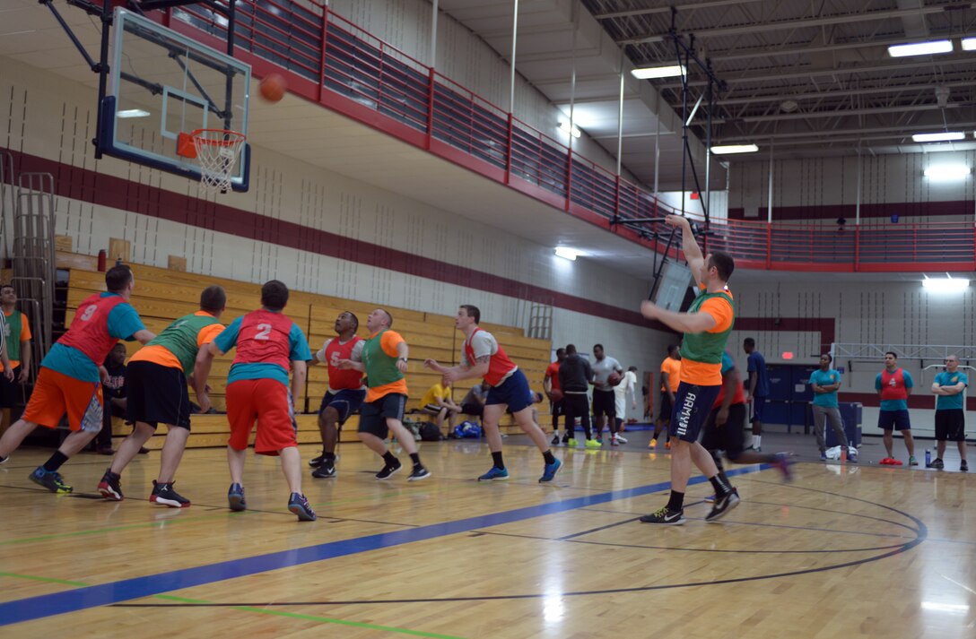Airmen participate in a game of basketball at the Bellamy Fitness Center at Ellsworth Air Force Base, S.D., April 29, 2016. The game was a part of Wingman Day and provided base personnel an opportunity to build camaraderie and practice teamwork within different groups. (U.S. Air Force photo by Airman Donald Knechtel/Released)