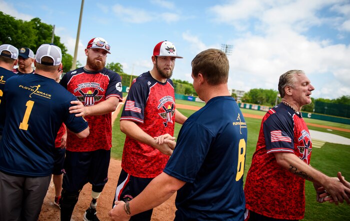 Members of the Wounded Warrior Softball Team and Joint Base Charleston softball team shake hands after the game April 23, 2016, at Patriot’s Point in Charleston, S.C. The WWAST is comprised of veterans and active-duty service members who have lost limbs but won’t let that disability to keep them from being competitive in athletics. They travel the country and play able-bodied softball teams competitively or through exhibition and celebrity games. (U.S. Air Force photo/Senior Airman Clayton Cupit)