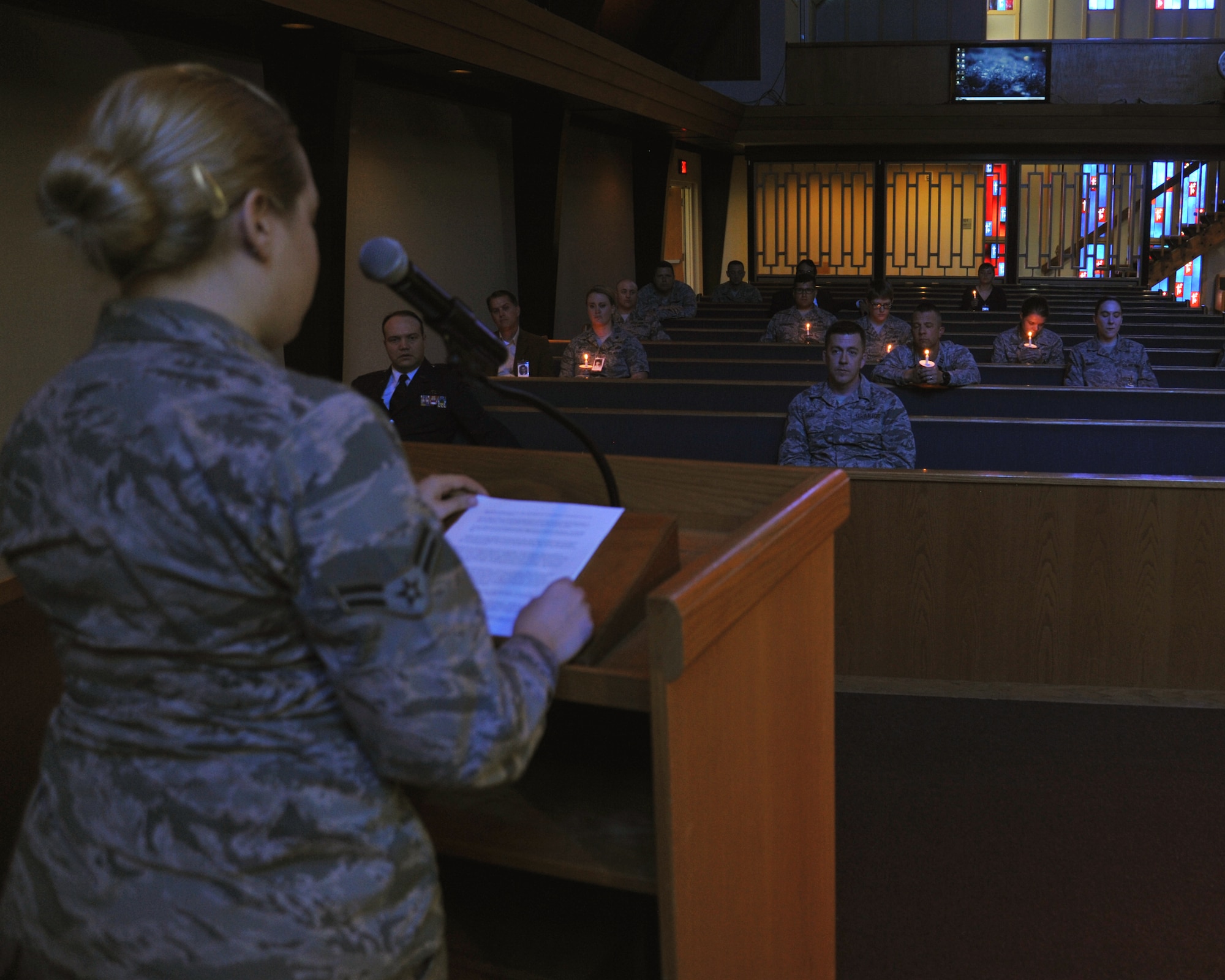 Members of Team Fairchild listen as Airman 1st Class Allison Hull shares the first person experience of a Holocaust survivor during the Holocaust Remembrance Day event May 4, 2016, at Fairchild Air Force Base, Wash. During the Holocaust, the Nazi regime and its collaborators persecuted and murdered six million Jews. Fairchild Airmen took the time to remember and honor not just the survivors, but also those who were killed during the Holocaust. (U.S. Air Force photo/Staff Sgt. Samantha Krolikowski)

