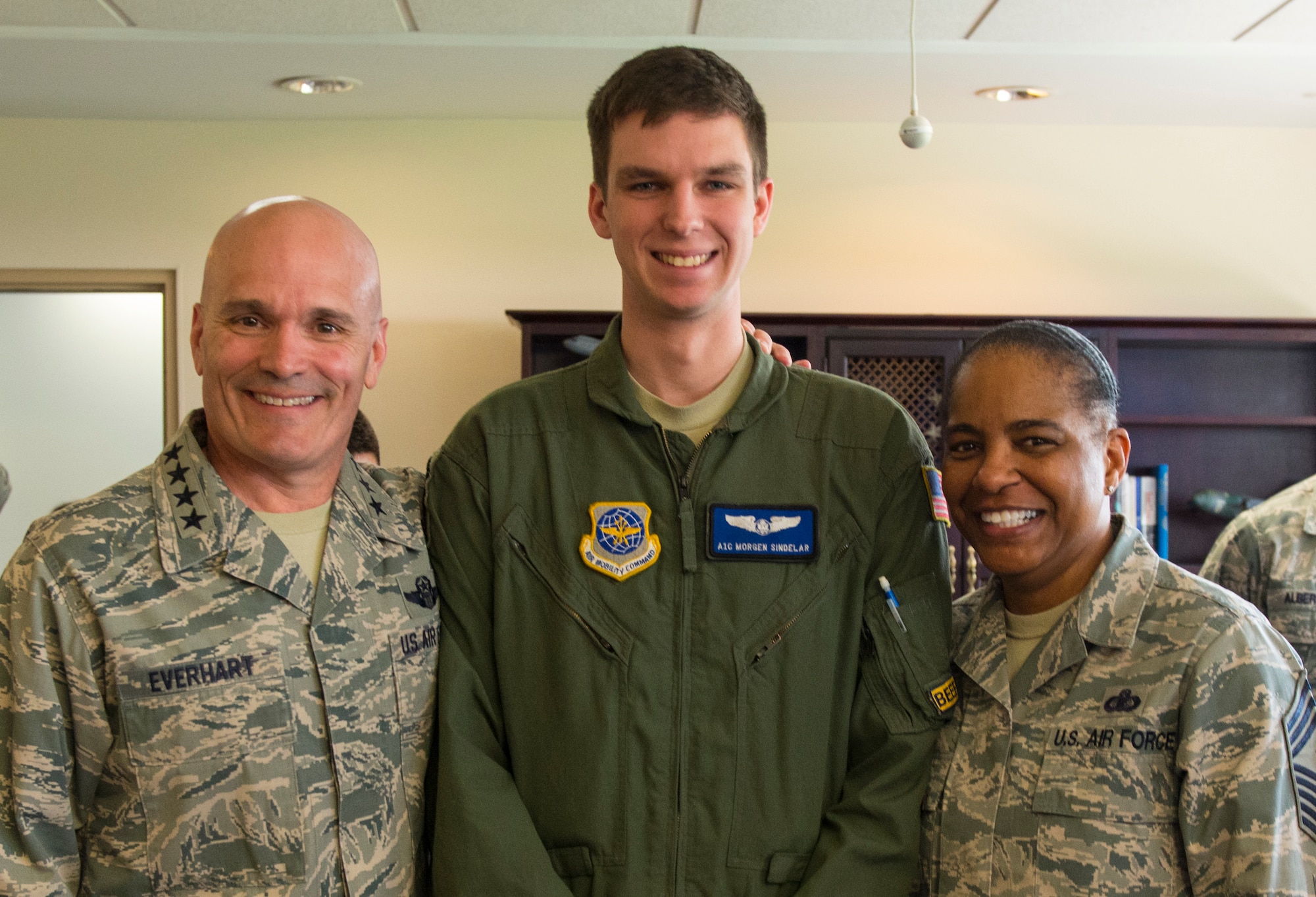 Gen. Carlton D. Everhart II, Air Mobility Command commander, surprises Airman 1st Class Morgen Sindelar, 305th Air Mobility Wing loadmaster, with Senior Airman below the zone, during his visit to Joint Base McGuire-Dix-Lakehurst, N.J. April 27, 2016. Everhart met with leaders from each of the five wings at JB MDL, toured the Airmen dormitories and held an all call during his visit. (U.S. Air Force photo by Senior Airman Joshua King) 