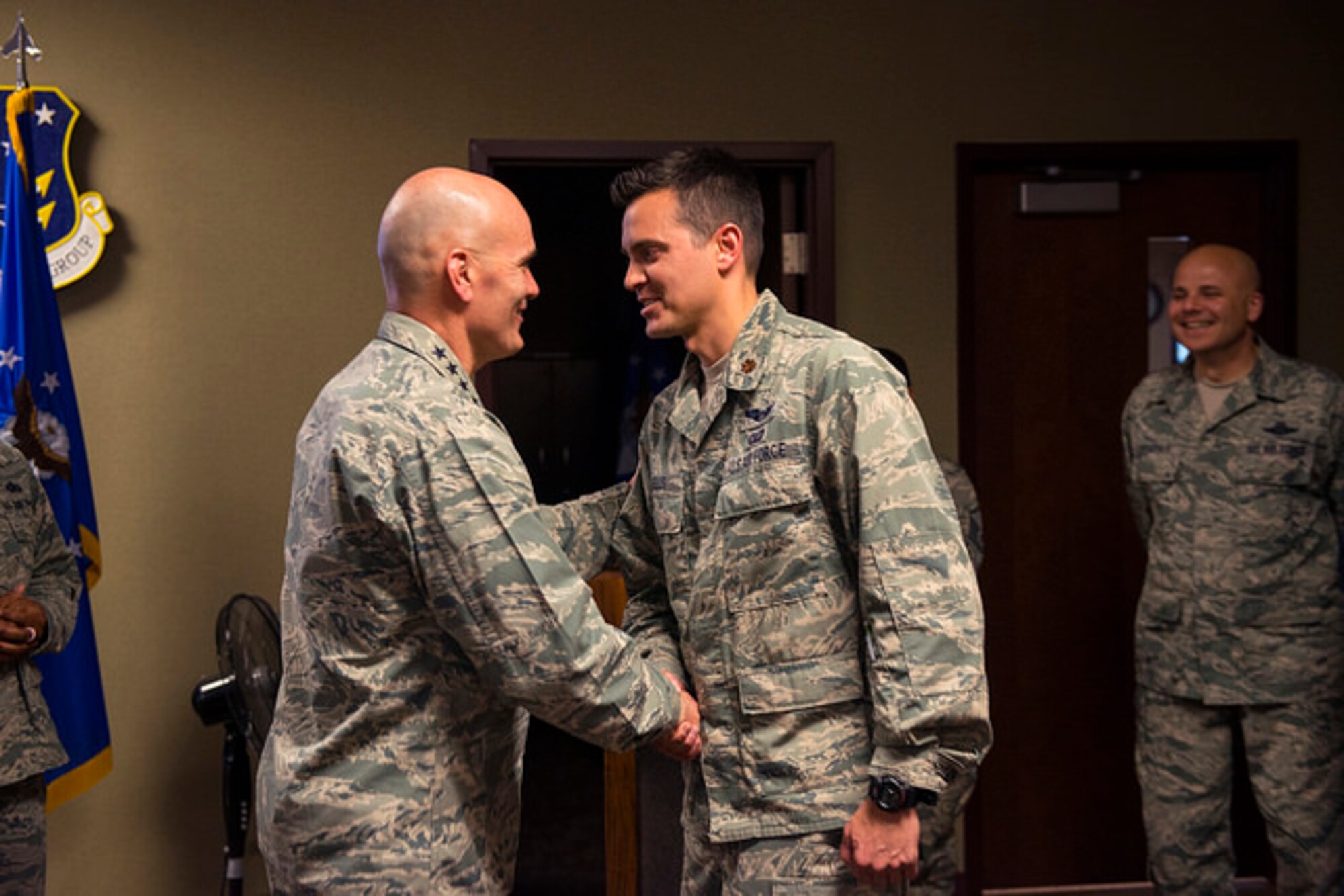 Gen. Carlton D. Everhart II, Air Mobility Command commander, shakes hands with Maj. Mike Wells, 305th Air Mobility Wing commander’s action group, during a star performer’s presentation during his visit to Joint Base McGuire-Dix-Lakehurst, N.J. April 26, 2016. Everhart met with leaders from each of the five wings at JB MDL, toured the Airmen dormitories and held an all call during his visit. (U.S. Air Force photo by Senior Airman Joshua King) 
