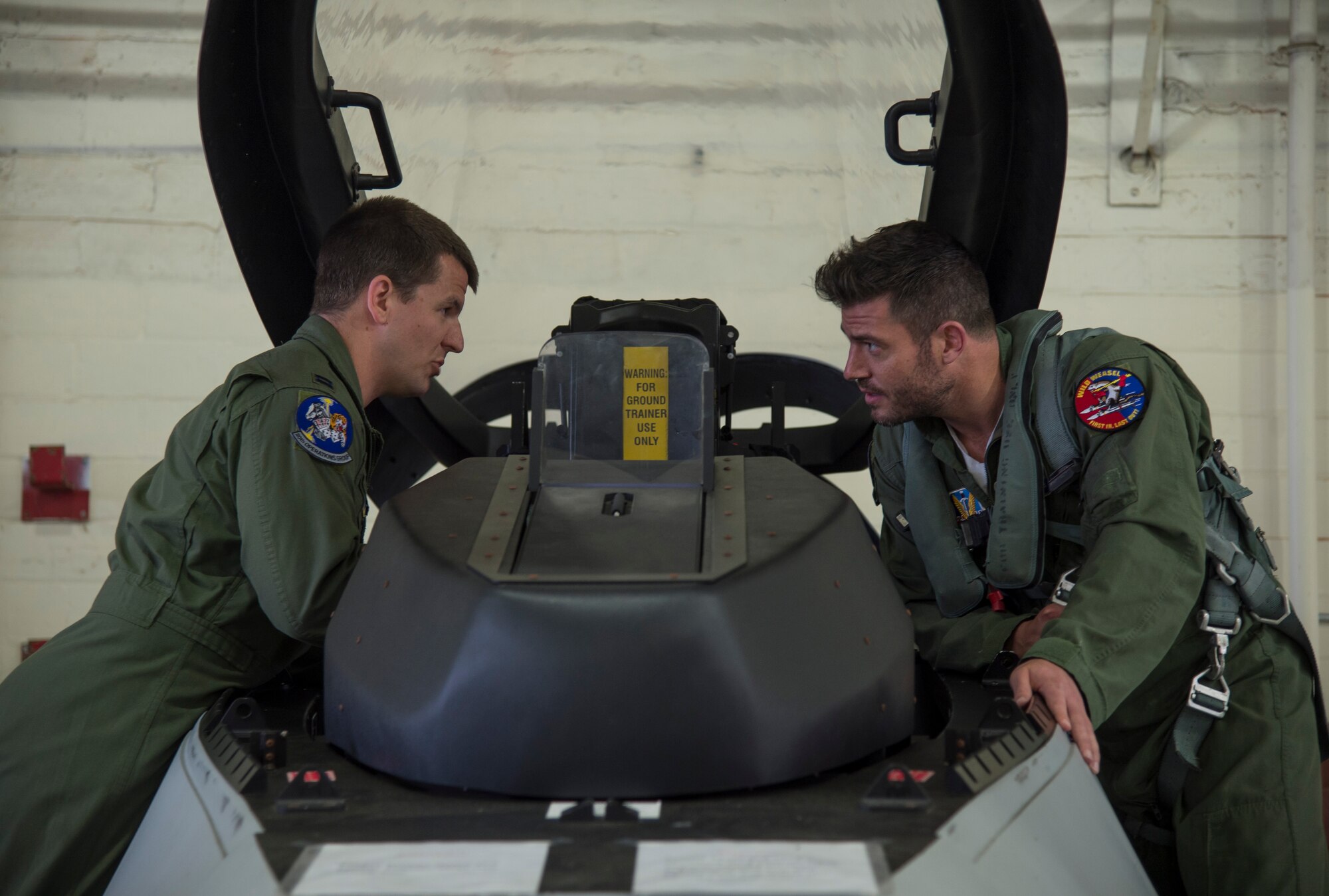 U.S. Air Force Capt. Jesse Hoover F-16 Fighting Falcon pilot, trains Jesse Palmer, correspondent for ABC’s Good Morning America, on the inside of a fighter jet during his visit at Langley Air Force Base, Va., May 3, 2016. Palmer received numerous flight trainings prior to his flight in an F-16. (U.S. Air Force photo by Senior Airman Kayla Newman)