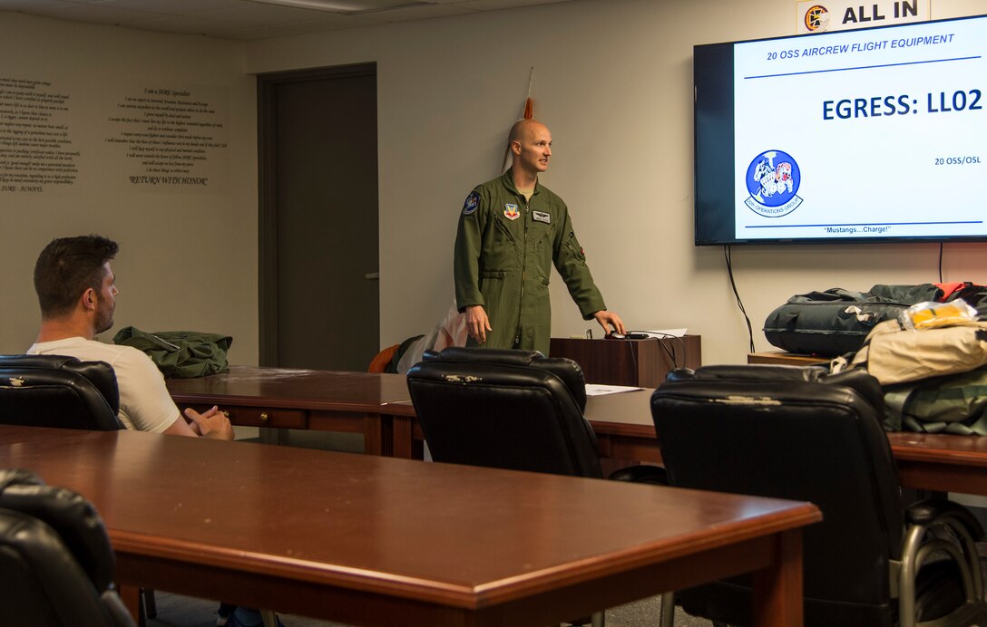 U.S. Air Force Capt. Michael Watts, F-16 Fighting Falcon pilot, teaches Egress training to Jesse Palmer, correspondent for ABC’s Good Morning America, during his visit at Langley Air Force Base, Va., May 3, 2016. Egress training was one portion of flight trainings that Palmer had to attend in order to fly in the F-16. (U.S. Air Force photo by Senior Airman Kayla Newman)