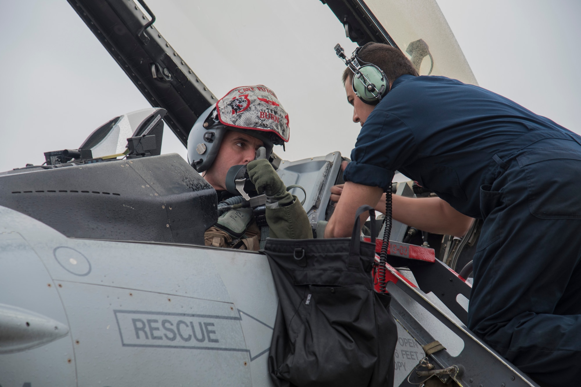 U.S. Air Force Airman 1st Class Mathew Flores, a crew chief with the 35th Aircraft Maintenance Squadron, straps Capt. Nicolas Dewulf, a pilot with the 13th Fighter Squadron, into an F-16 Fighting Falcon at Misawa Air Base, Japan, May 4, 2016. After climbing into the cockpit, a pilot’s vest must be connected to the parachute which will deploy in the event of an ejection. Crew chiefs are responsible for inspecting the aircraft for mechanical and electronic issues before and after flight. (U.S. Air Force photo by Airman 1st Class Jordyn Fetter)