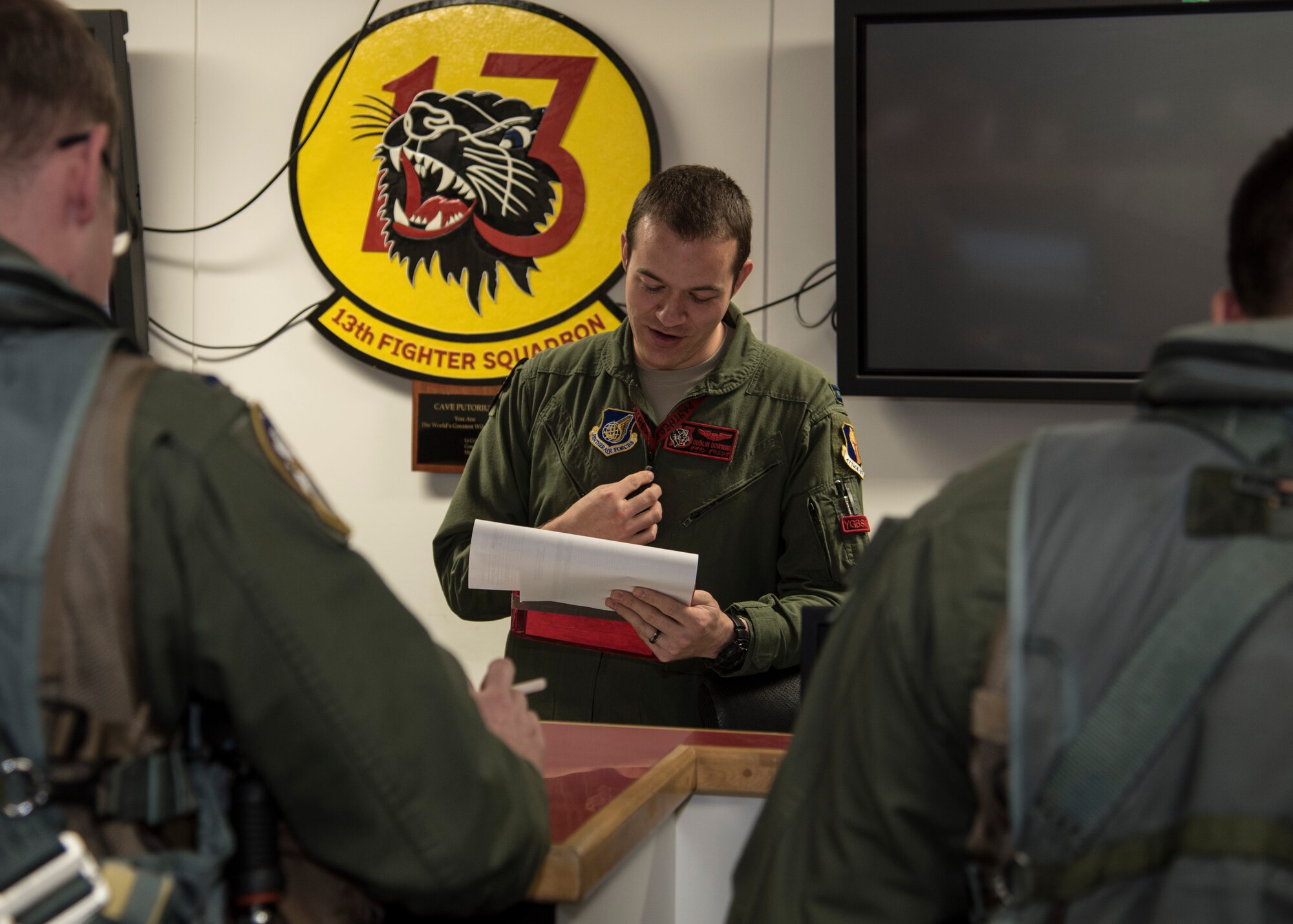U.S. Air Force Capt. Philip Downing, an F-16 Fighting Falcon pilot with the 13th Fighter Squadron, briefs pilots on the status of F-16s at Misawa Air Base, Japan, May 4, 2016. Downing acts as a conduit between pilots and maintainers so all information regarding the safety and condition of the aircraft is accurately relayed. (U.S. Air Force photo by Airman 1st Class Jordyn Fetter)