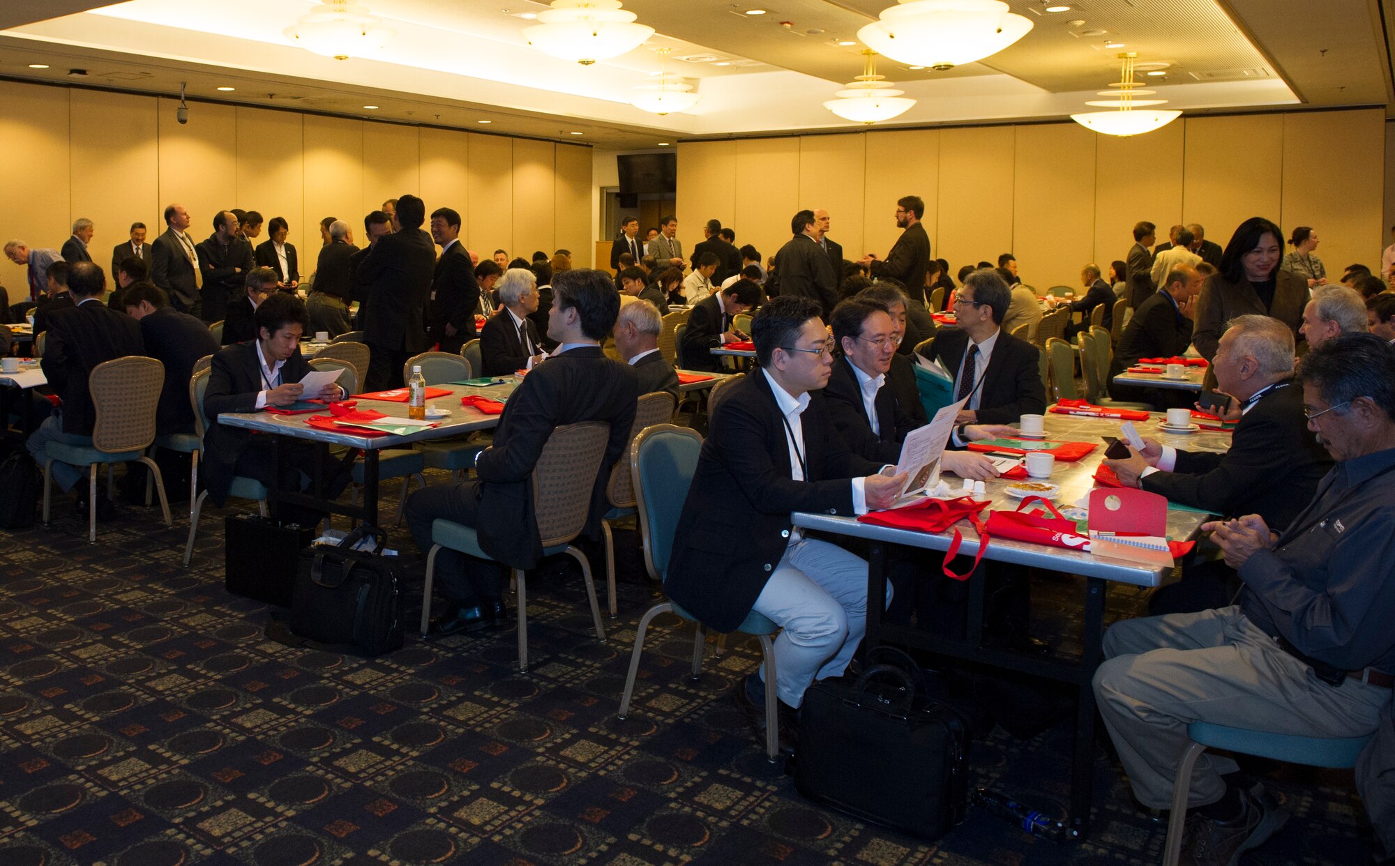 Japanese and American business representatives gather before the start of Industry Day at Yokota Air Base, Japan, April 28, 2016. The event, led by the 374th Civil Engineer Squadron, 374th Contracting Squadron, United States Forces, Japan, and the Society of American Military Engineers, was an opportunity for U.S. government organizations to build partnerships with industries from throughout Japan in the wave of new construction projects throughout the region. (U.S. Air Force photo by Senior Airman Delano Scott/Released)